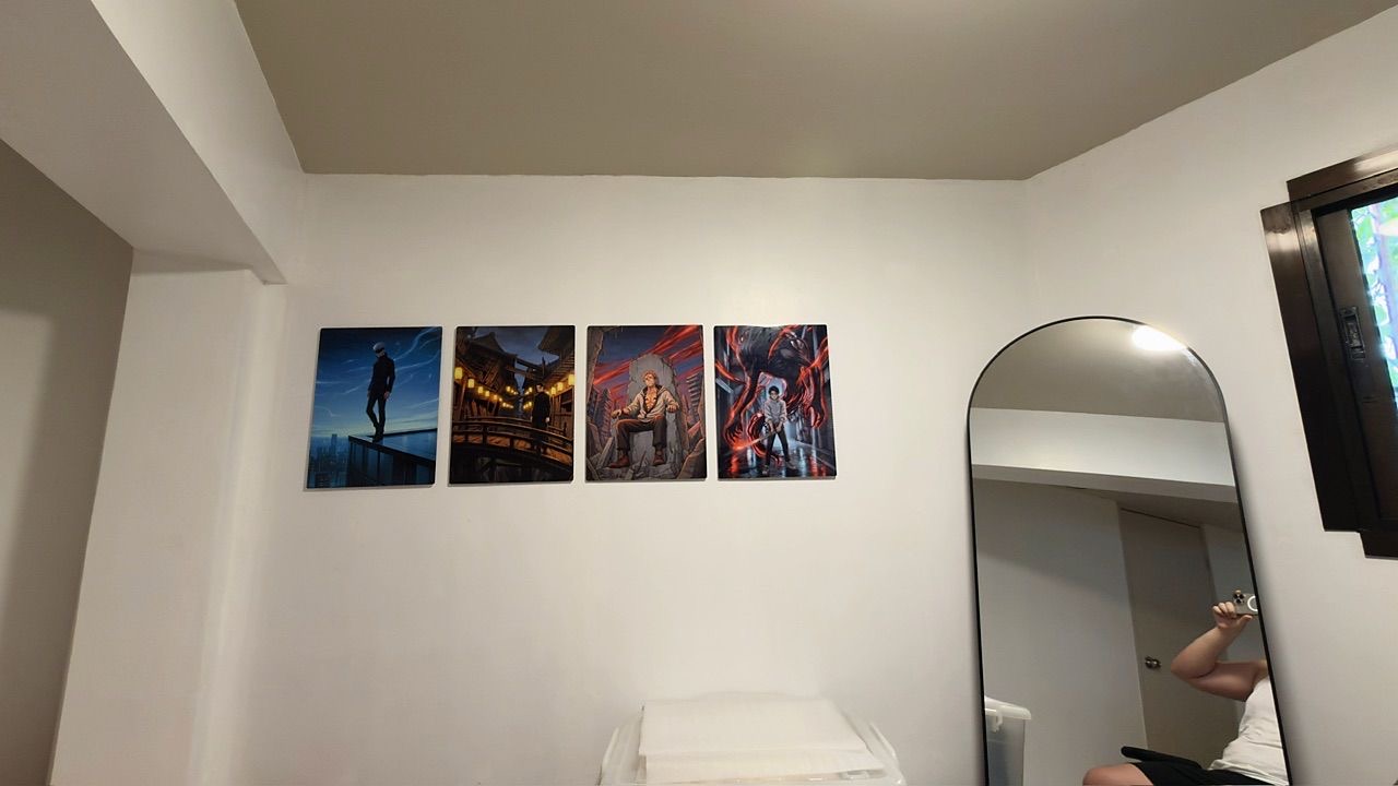 Four Metalix artwork prints displayed together on a bedroom wall